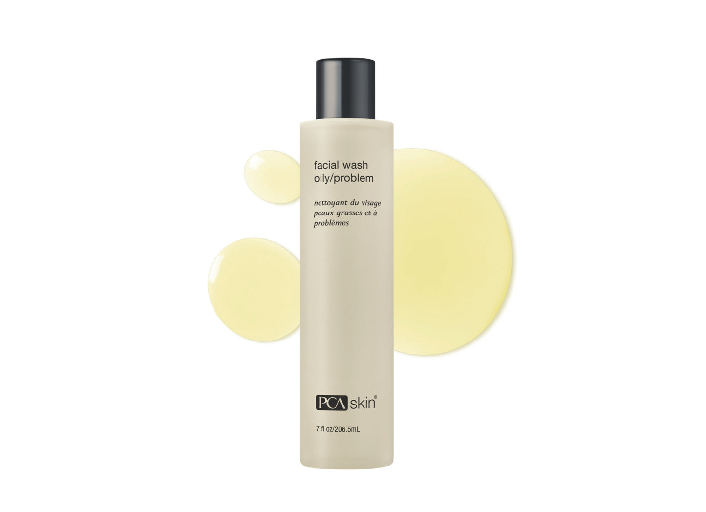 Facial wash bottle with yellow circular designs on a white background