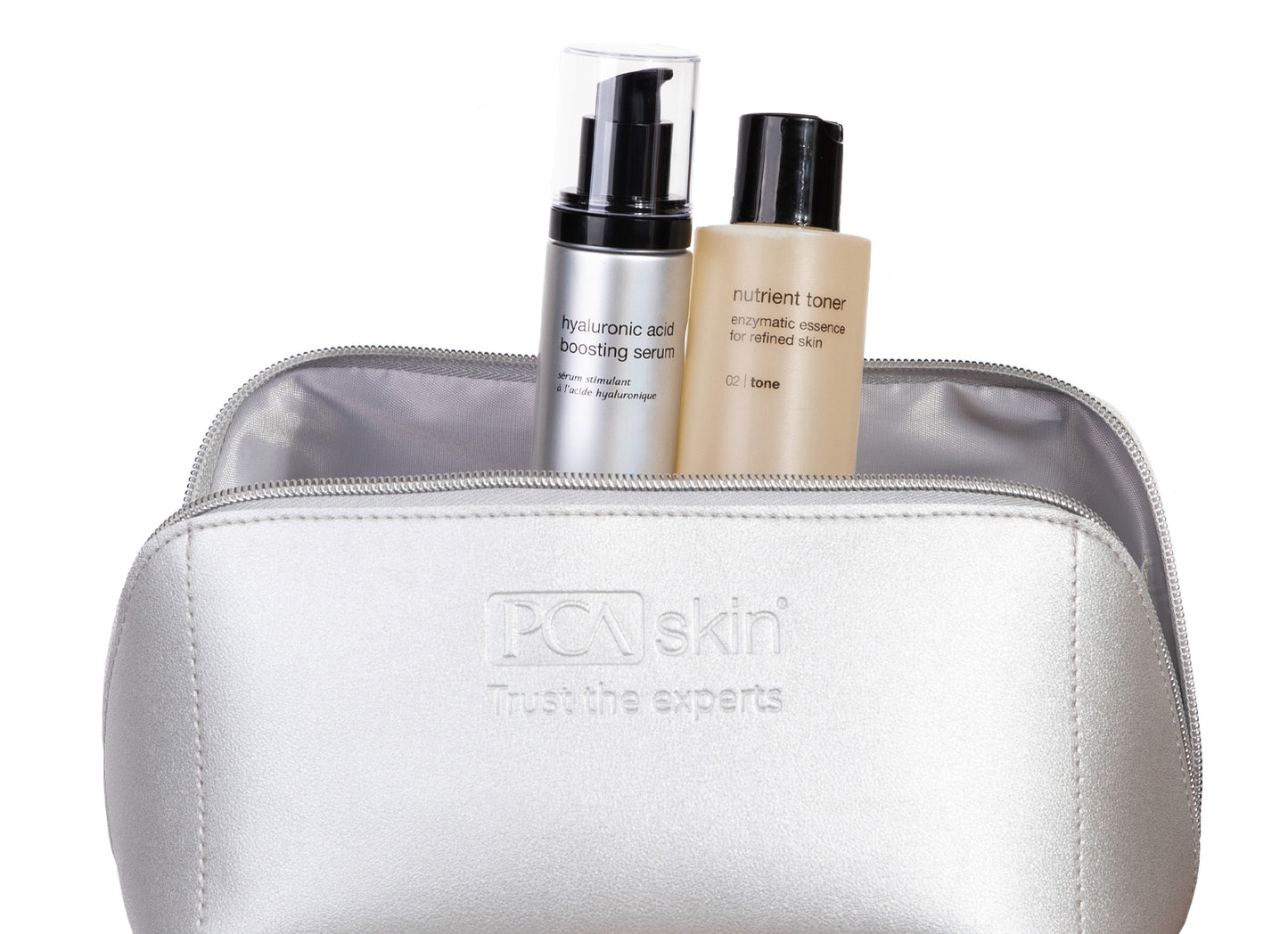 Silver cosmetic bag with skincare products on a white background